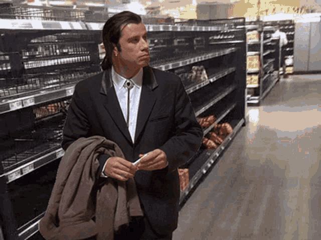 Travolta confused in empty store — Reaction meme