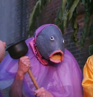 Guy in fish costume holding plunger — Reaction meme