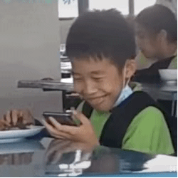 Boy Enjoying Phone while Eating — Reaction meme